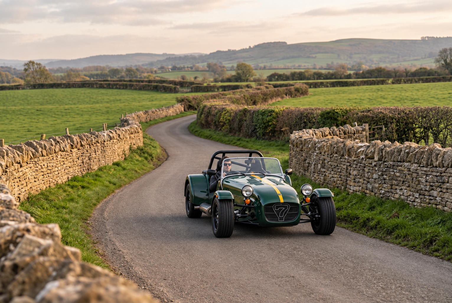 Green Seven-style sports car on a Cotswold lane